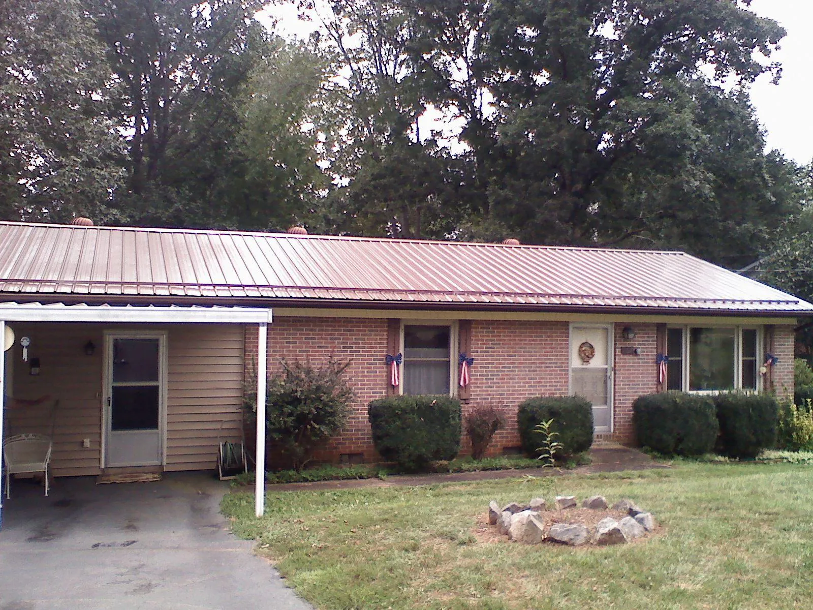 Bronze metal roof and carport on a brick ranch home — Roof Repair work by our crew in Clinton Corners